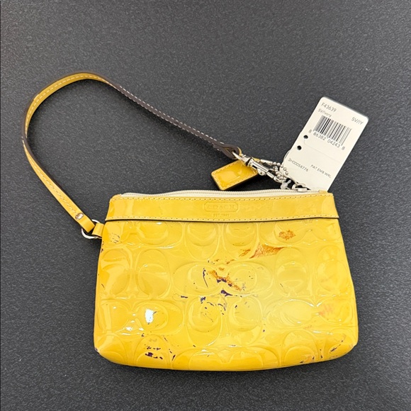 Coach Handbags - Coach Yellow Embossed Wristlet
